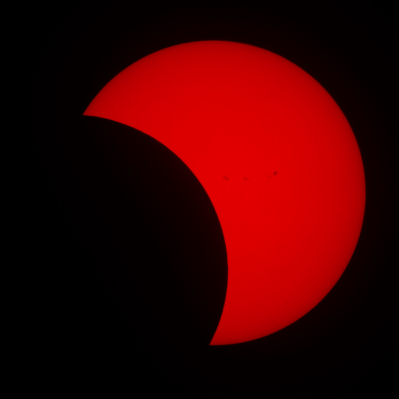 Eclipse in H-alpha showing sunspots