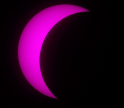 Eclipse in near-ultraviolet showing faint sunspots