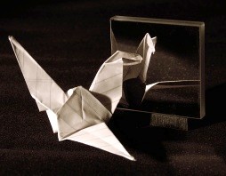Origami bird seeing its reflection