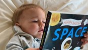 Baby reading astrophysics book